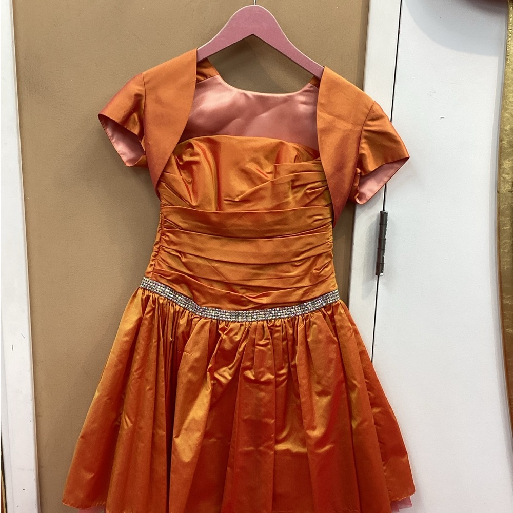 2 piece matching dress and jacket with a vibrant hue of orange